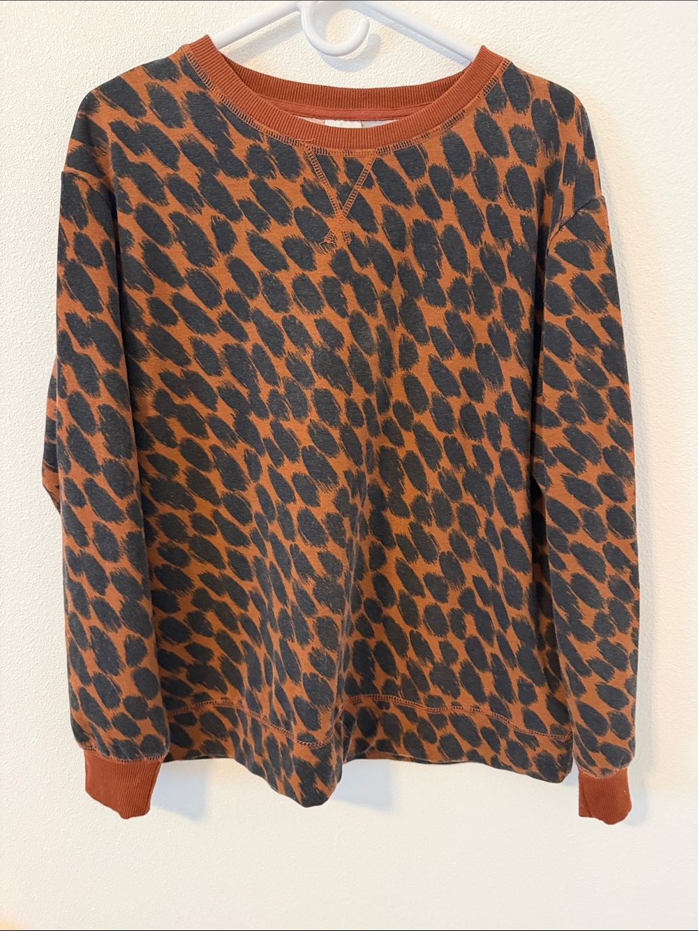 stars above women’s Leopard-Print Crewneck Sweater in Rust and Black